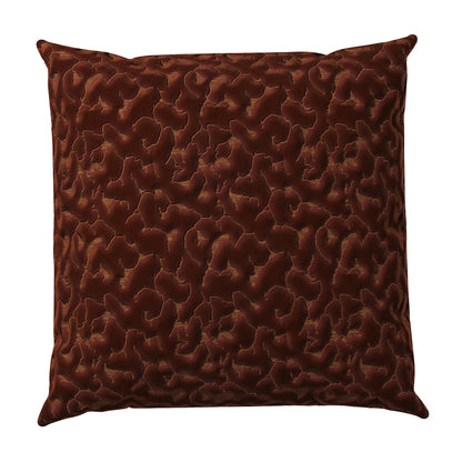 Copper colored throw pillow with an abstract texture.