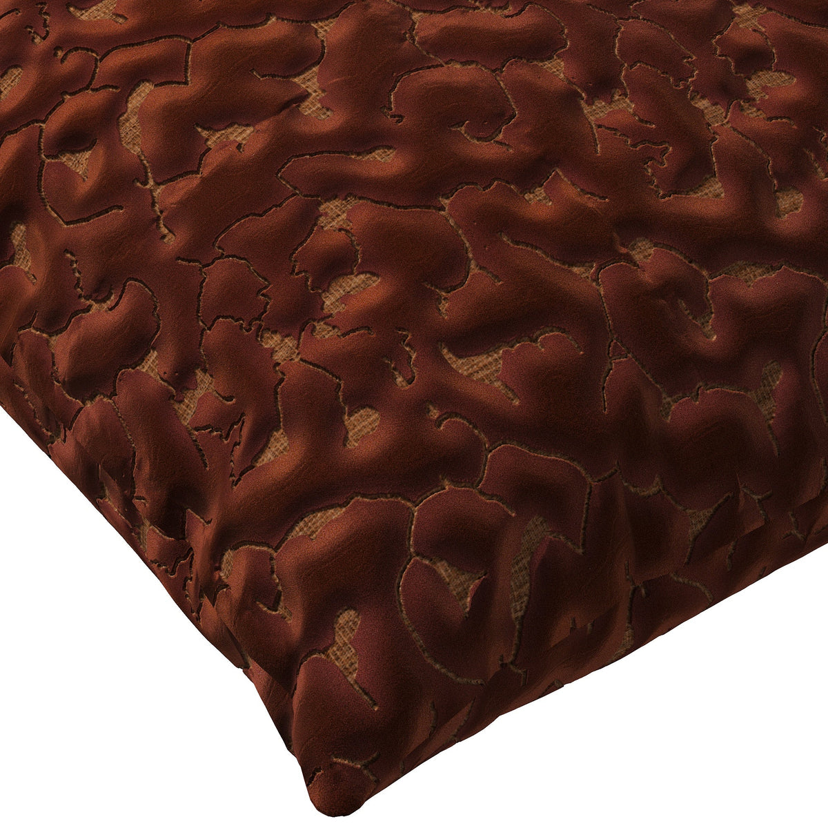 Copper colored throw pillow with an abstract texture.